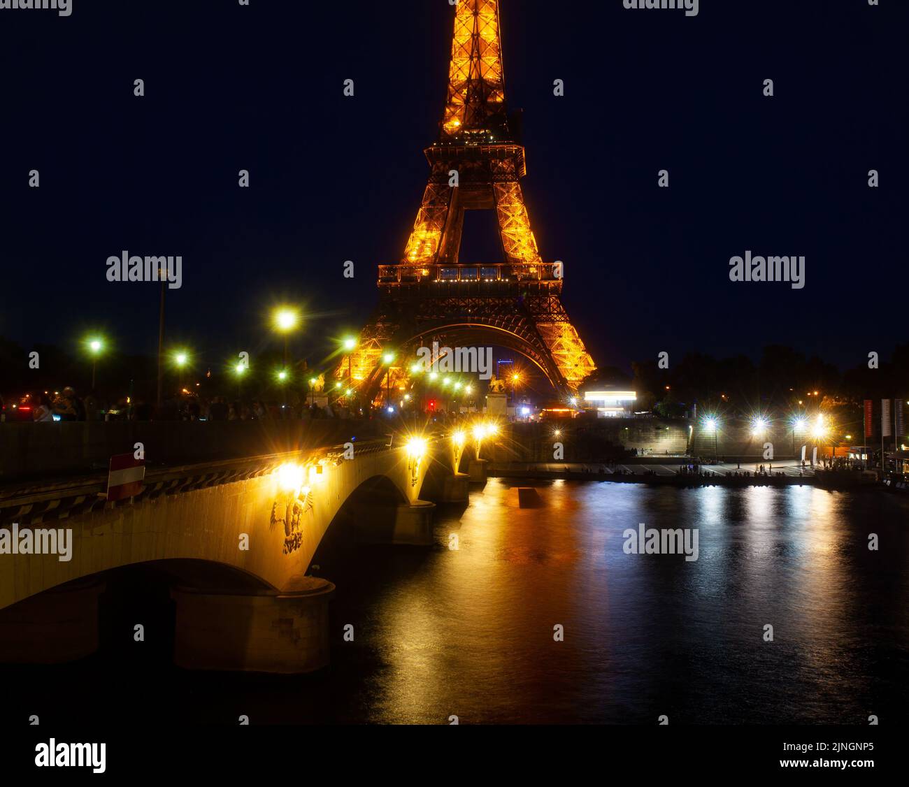 Paris, France July, 13 Eiffel Tower brightly illuminated at dusk in