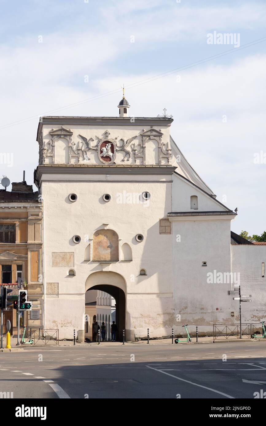 17th century Gate of Dawn Vilnius Lithuania. People entering through the only gate left of the wall into Vilnius old town; Vilnius Lithuania Europe Stock Photo
