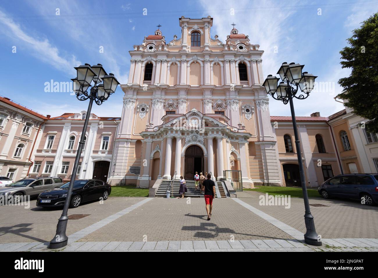 People outside the Church of St. Casimir exterior, a baroque 17th century catholic church, Vilnius old town, Vilnius, Lithuania Europe Stock Photo