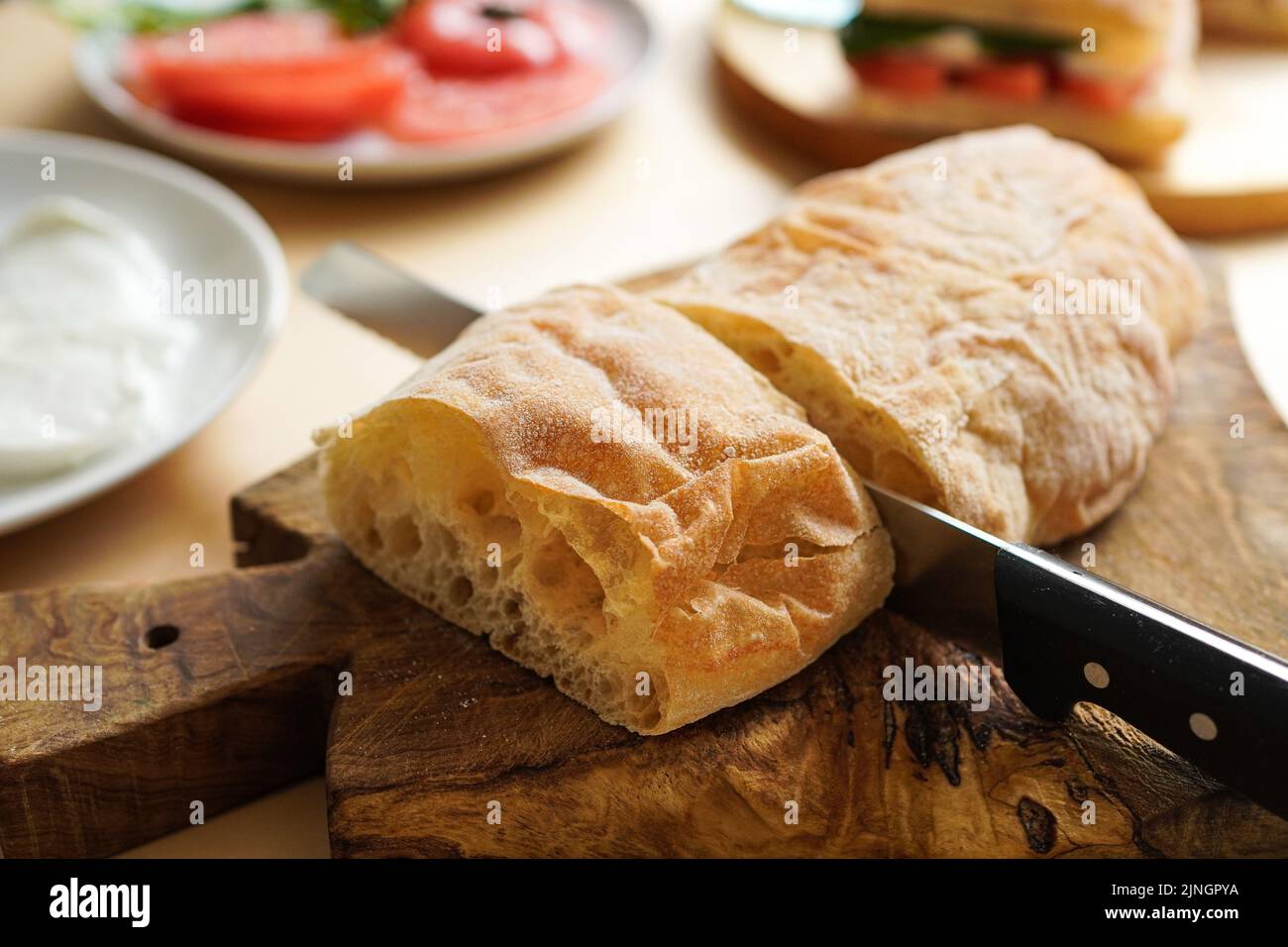 Cutting bread at the table to make sandwiches Stock Photo Alamy