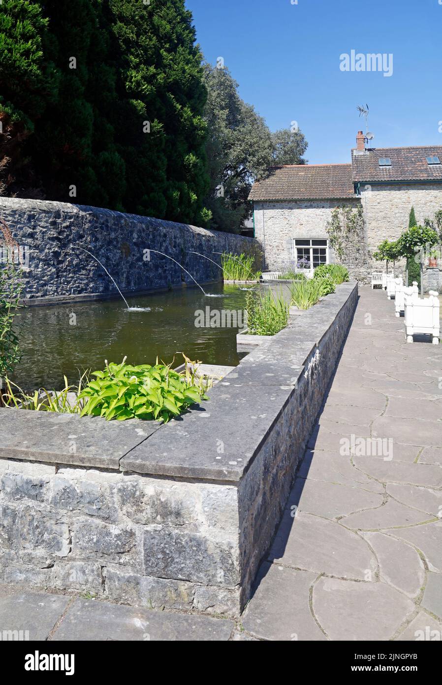 The Italian Garden at St Fagans National Museum of History. Summer 2022. August. Water feature with plants and waterspouts Stock Photo