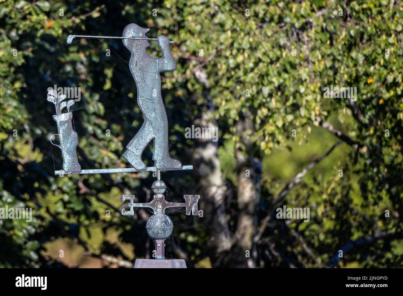 Weather vane with golfer and clubs on roof top in Lychett Matravers, Dorset, UK on 11 August 2022 Stock Photo