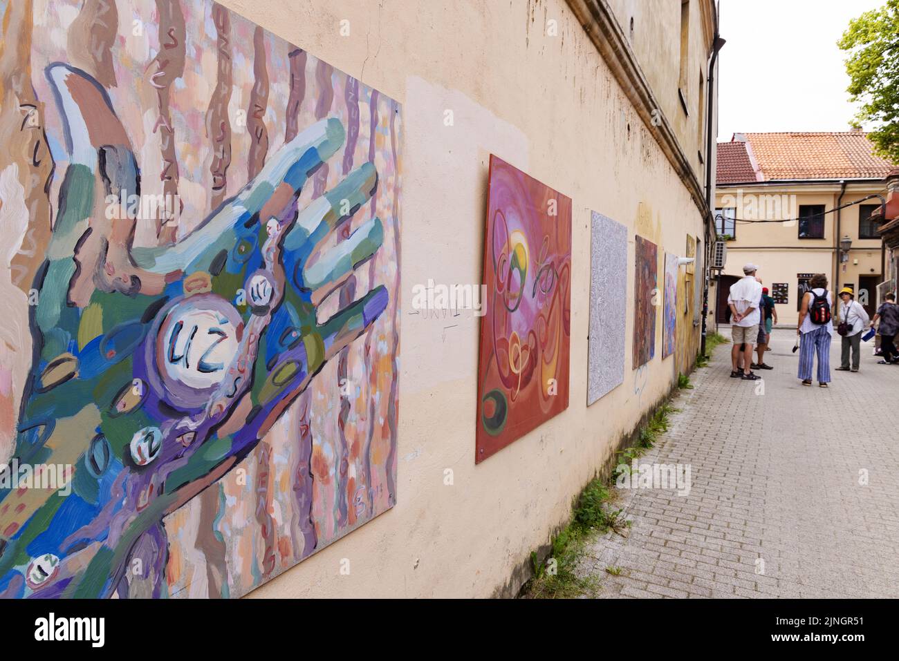 Lithuania tourism, tourists looking at the street art in the independent republic of Uzupis Vilnius, Lithuania Europe Stock Photo