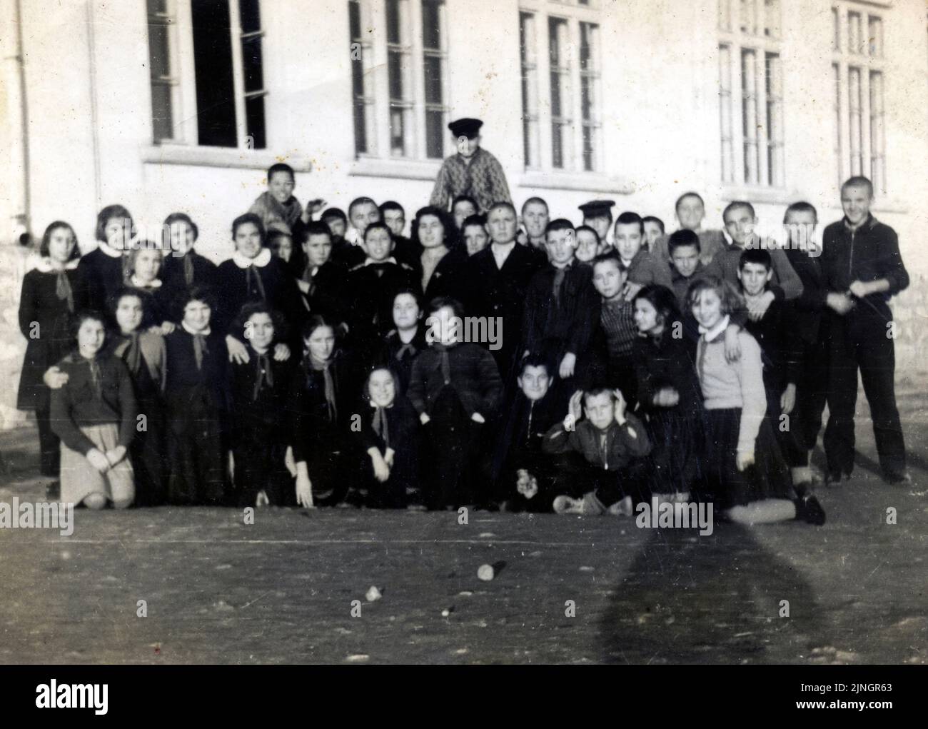 Group portrait of schoolgirls and schoolboys outside school building in the late 50s, Bulgaria Stock Photo