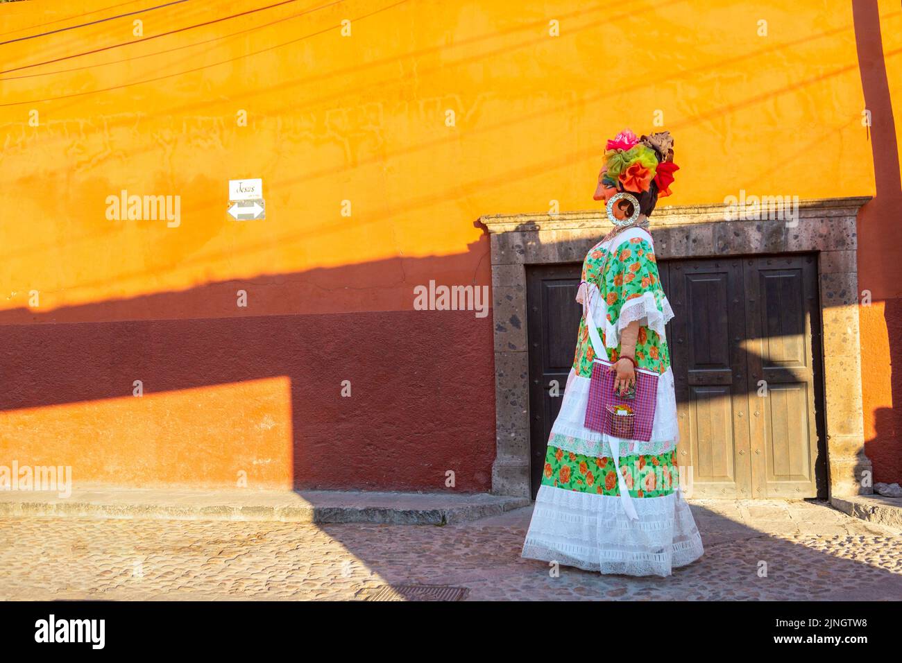 A mojiganga, or giant puppet made from papier mâché walks through the historic city center of San Miguel de Allende, Mexico. Stock Photo