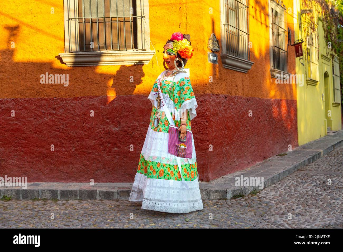 A mojiganga, or giant puppet made from papier mâché walks through the historic city center of San Miguel de Allende, Mexico. Stock Photo
