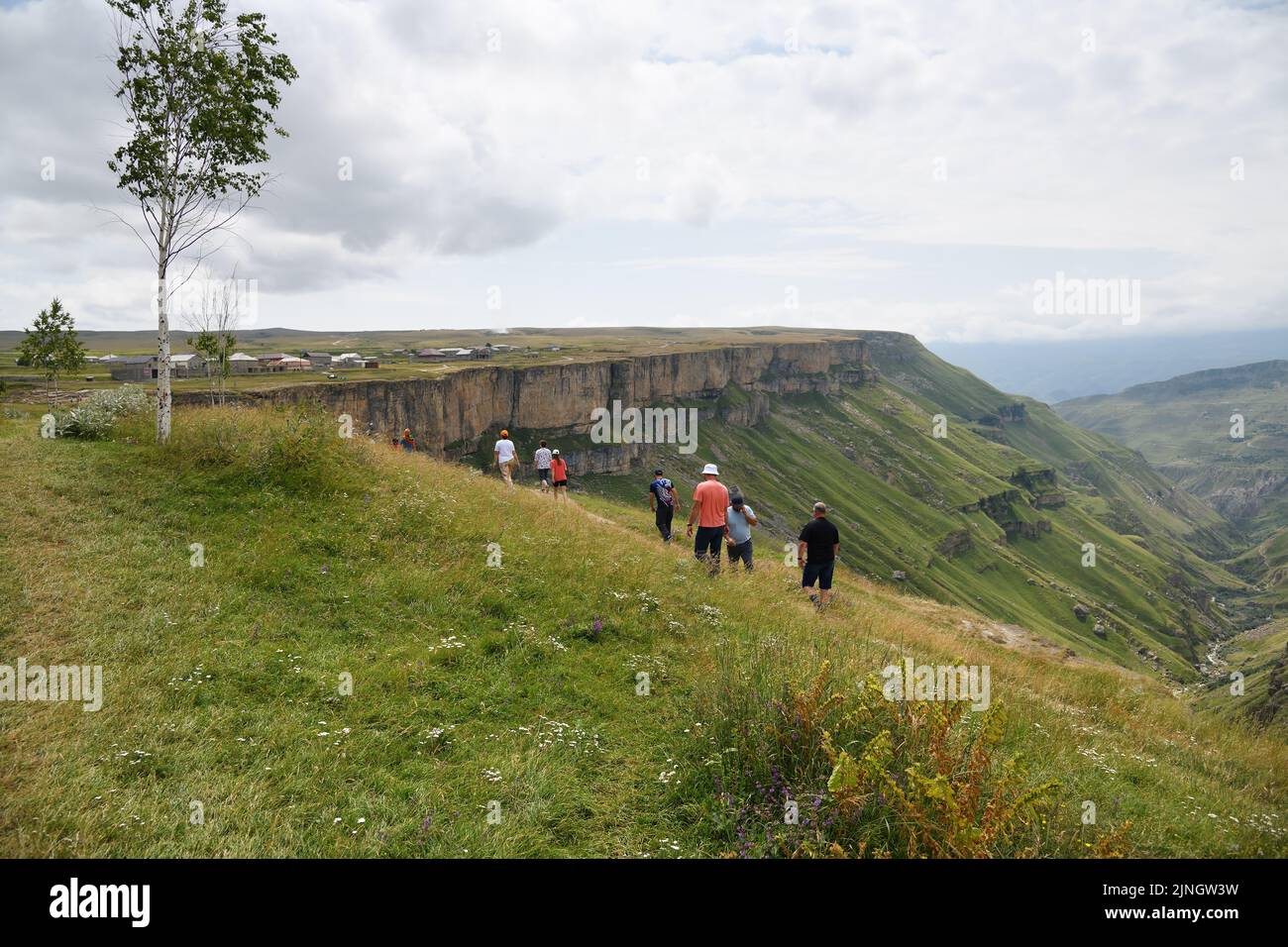 Dagestan, Russia - 21 July, 2022:  People walk on the edge of the Khunzakh Canyon in the Republic of Dagestan, Russia. Stunning landscape of the Cauca Stock Photo