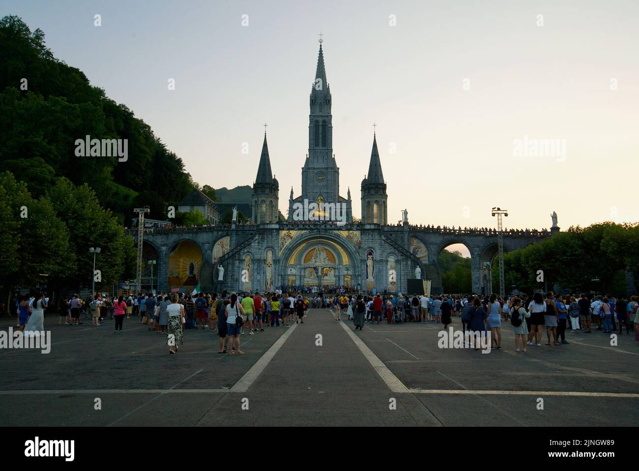People gathered at Sanctuaires NotreDame de Lourdes, at night. A