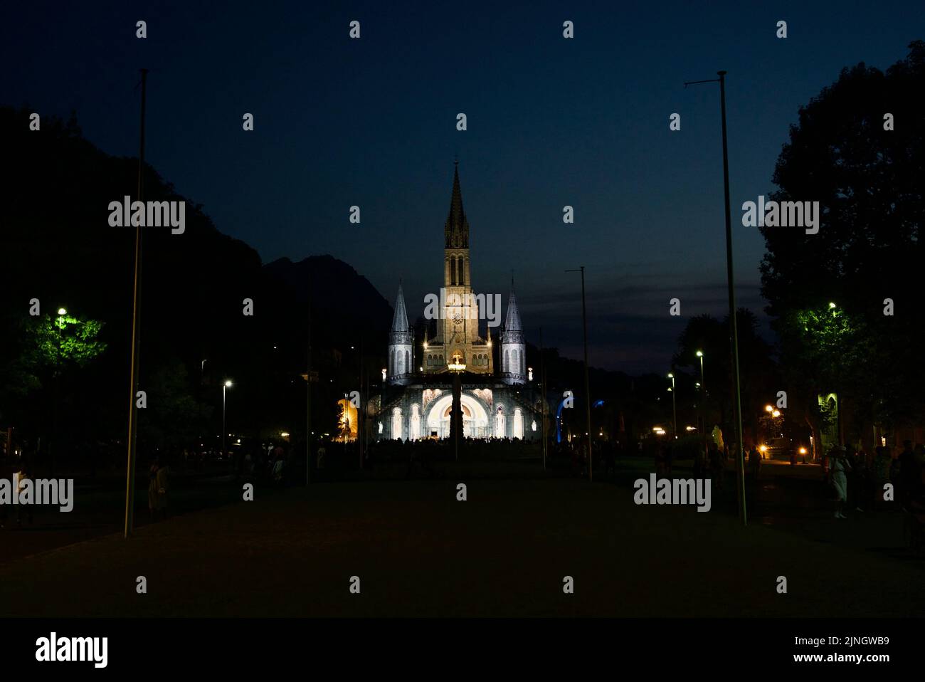 People gathered at Sanctuaires NotreDame de Lourdes, at night. A