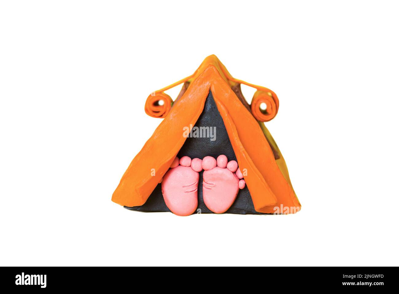 The heels stick out of the orange tent. Made from plasticine. Isolated on white. Stock Photo
