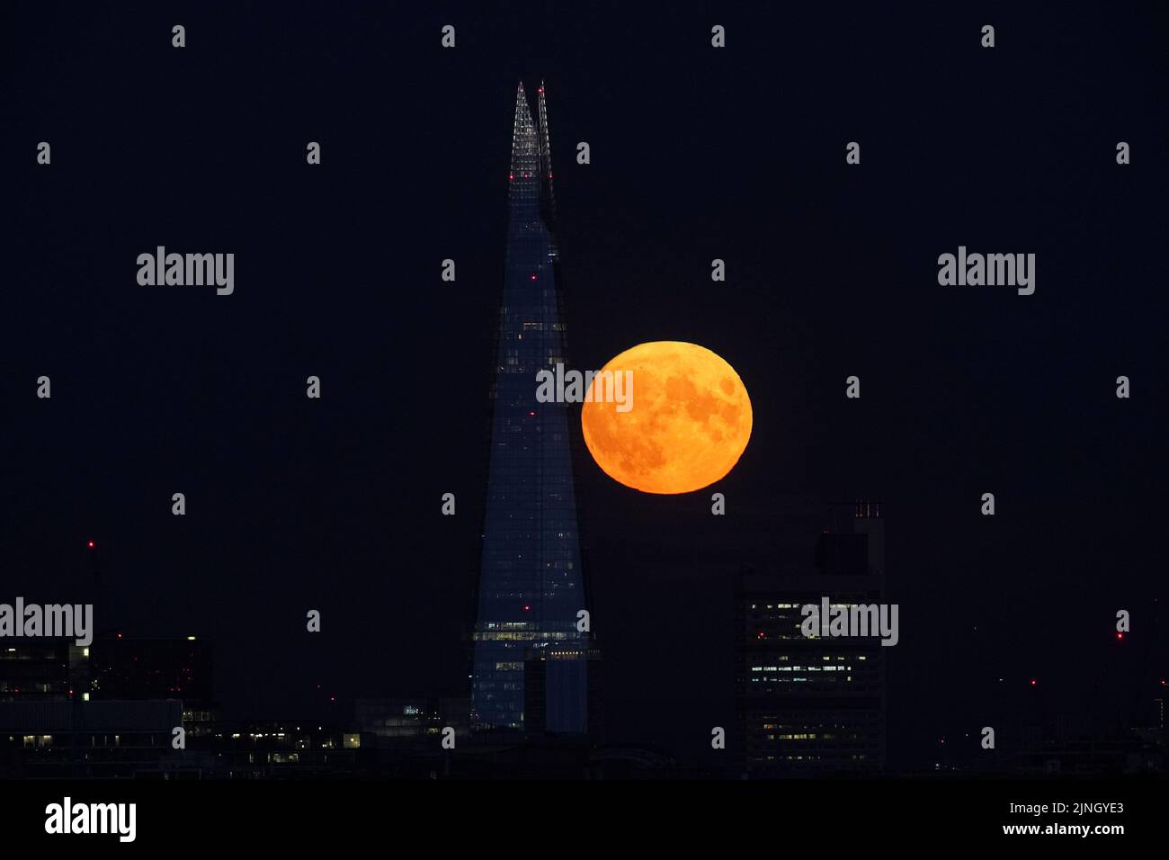 The Sturgeon supermoon, the final supermoon of the year, rises behind The Shard in London. Picture date: Thursday August 11, 2022. Stock Photo