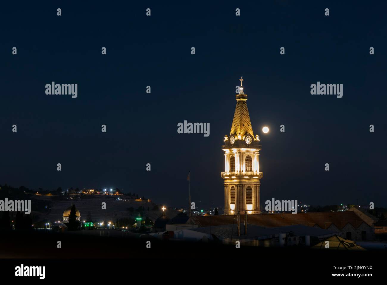 The Sturgeon full moon shines behind the bell tower of the Franciscan Saint Saviour or San Salvador monastery located in Saint Francis street in the Christian Quarter in the old city East Jerusalem Israel Stock Photo