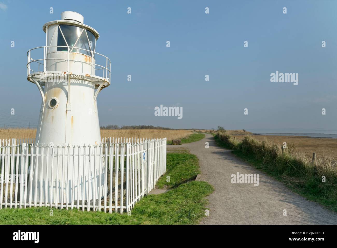 East Usk lighthouse with extensive reedbeds and the Severn Estuary in the background, RSPB Newport Wetlands Nature Reserve, Gwent, Wales, UK, March Stock Photo