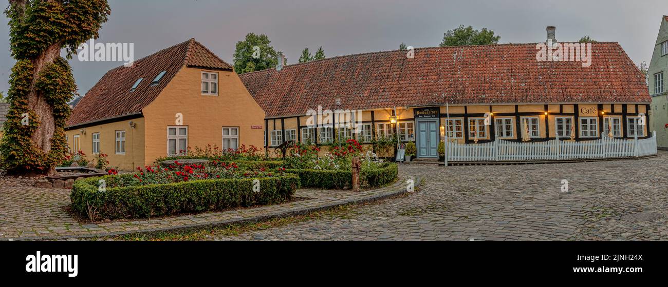 Panoramic wiev of an old timber framed hotel in the dusk evening light at the cobbelstone square in Mariager, Denmark, August 7, 2022 Stock Photo
