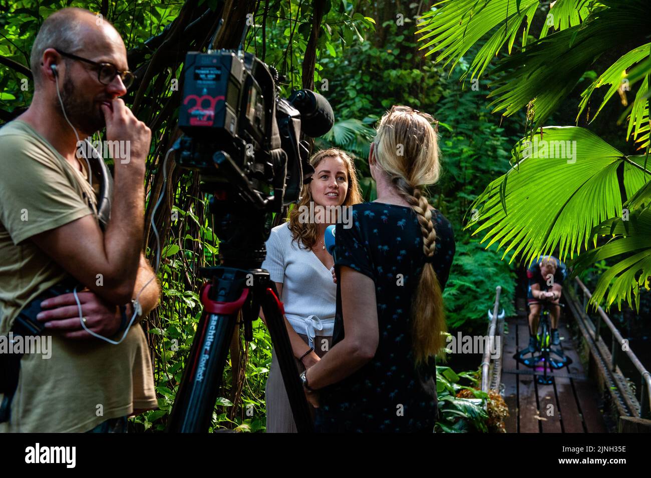 Athlete Olaf Van Den Bergh's girlfriend seen being interviewed. Dutch top athlete Olaf Van Den Bergh starts training in the indoor tropical rainforest of the Burgers' Zoo in Arnhem, in preparation for the Ironman World Championships in Kailua-Kona located in Hawaii. The Bush (indoor tropical rainforest) is the ideal training location because of the high humidity and temperature. Stock Photo