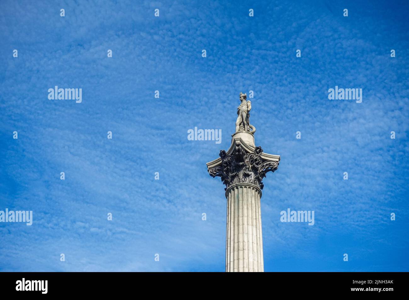 London, UK- July 4, 2022: Trafalgar Square. Nelson on top of his column, isolated against spotted blue cloudscape. Stock Photo