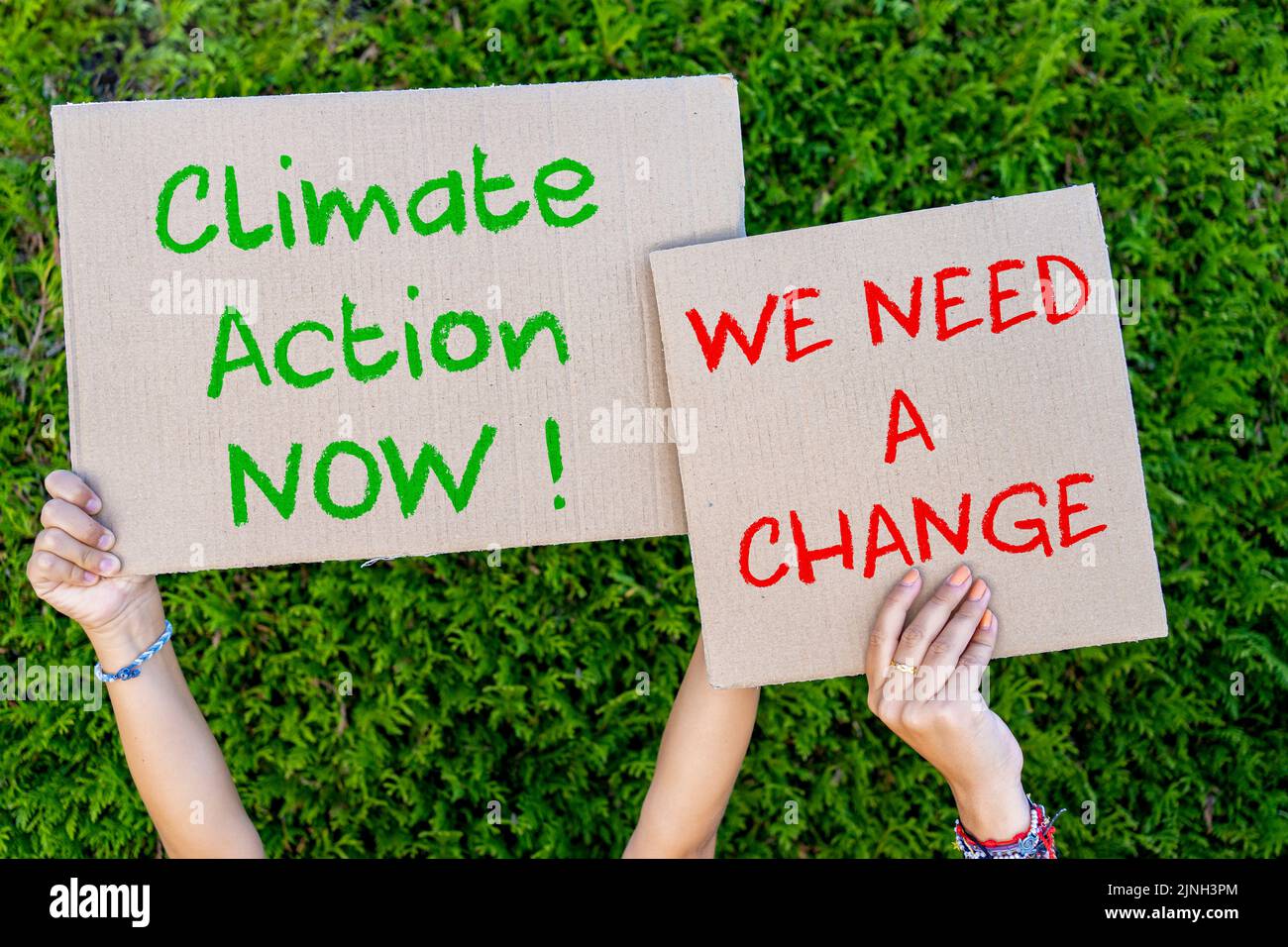 Activists with ' Save the planet' and 'We need a change' placard at climate change prostest Stock Photo
