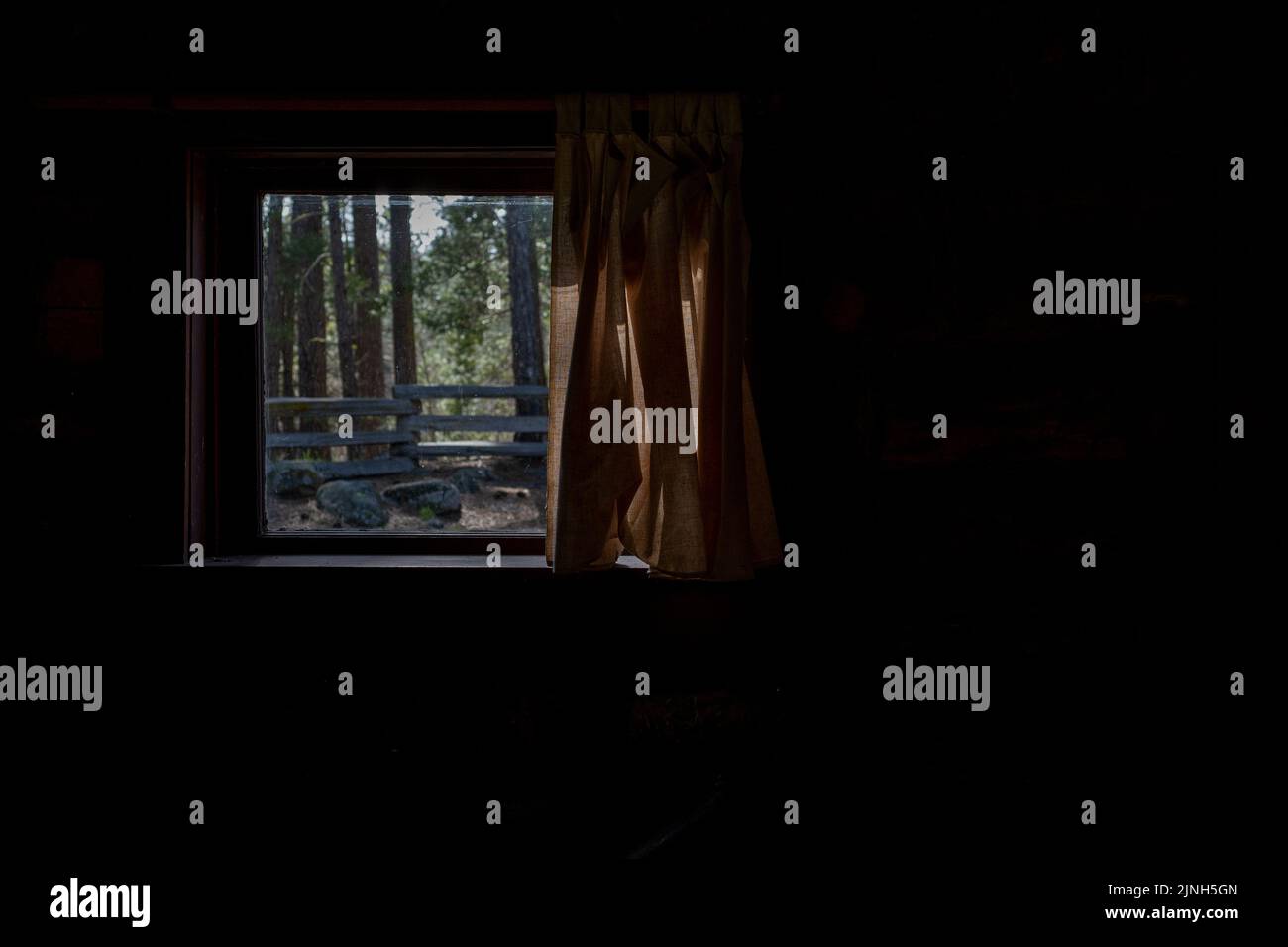 Window From Inide Photo Looking through the window from inside log cabin view of wooden fence ...