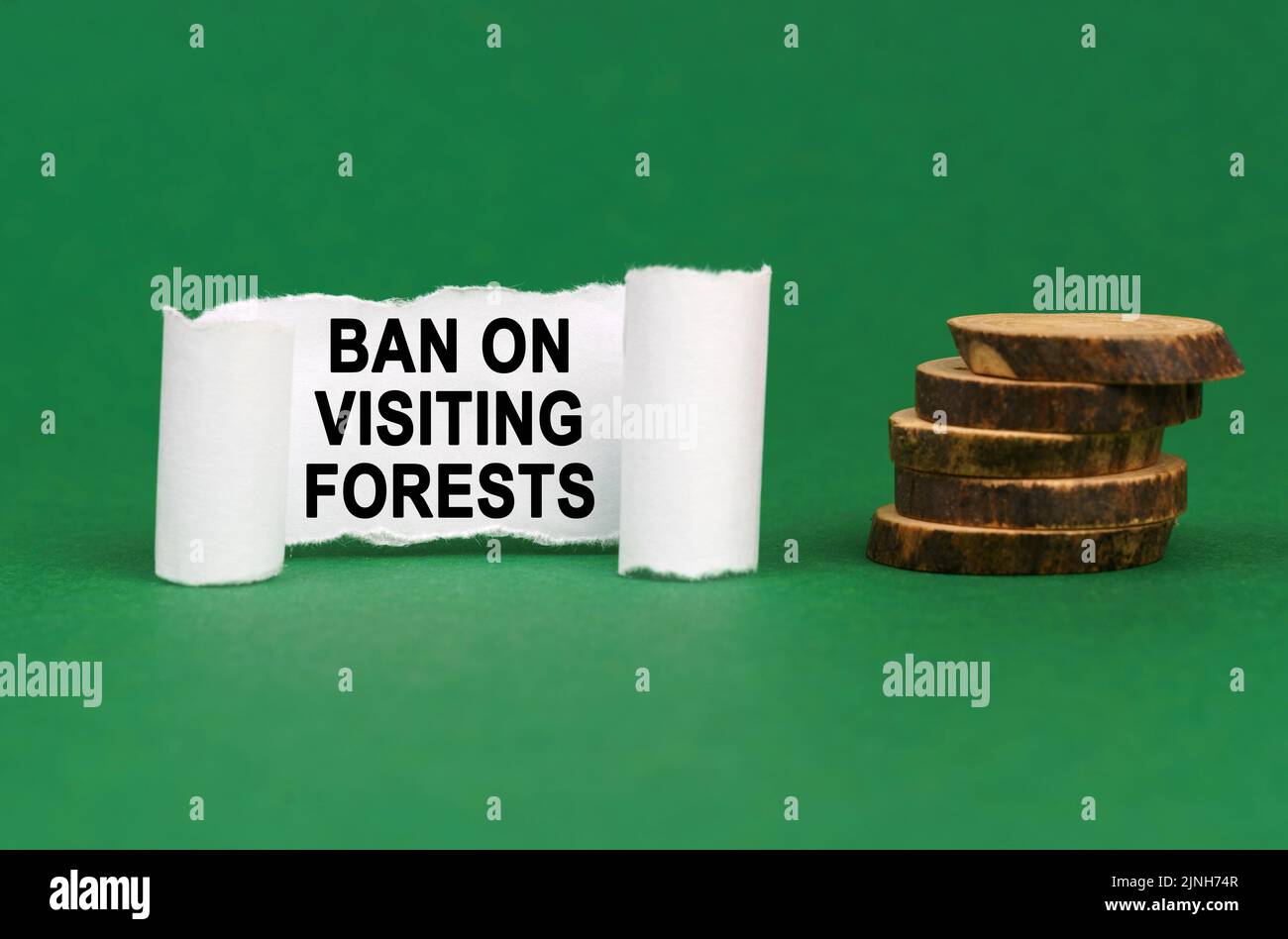 Ecological concept. On a green surface, wooden circles and a white