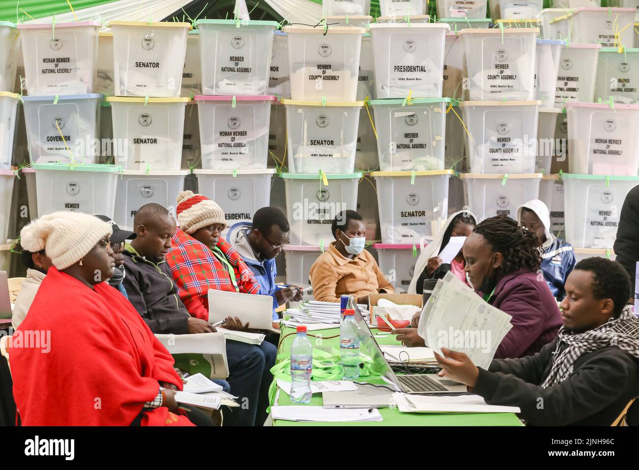 Nairobi, Kenya. 11th Aug, 2022. The Independent Electoral and Boundaries Commission (IEBC) presiding officers (L) hand over election results from their polling stations to the returning officer (R) at Starehe Constituency tallying center in Nairobi. Tallying of results continue from Kenya's general elections which was held on 9th August 2022. (Credit Image: © Boniface Muthoni/SOPA Images via ZUMA Press Wire) Stock Photo