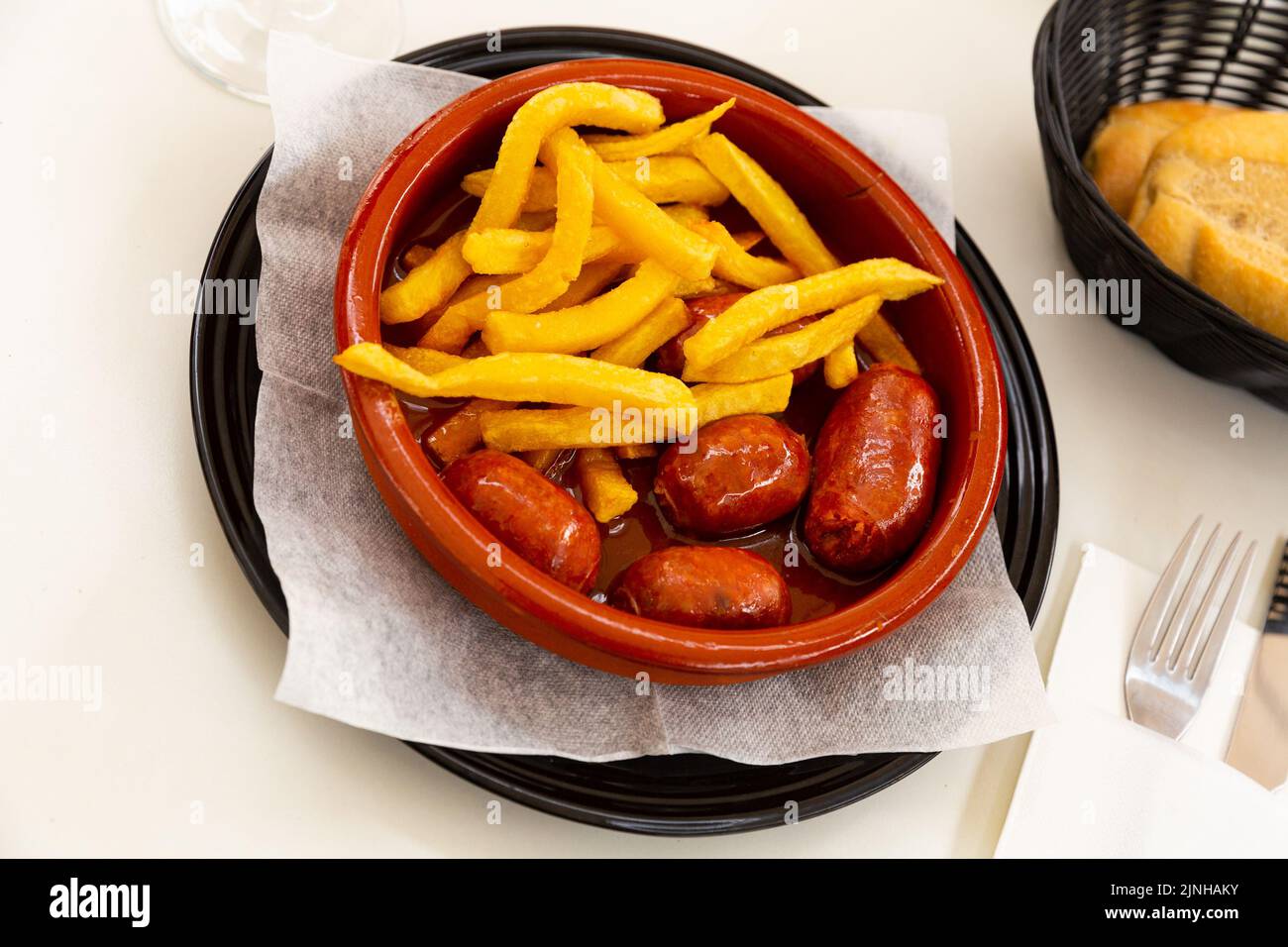 Popular Spanish tapa of smoked chorizo cooked in cider Stock Photo - Alamy