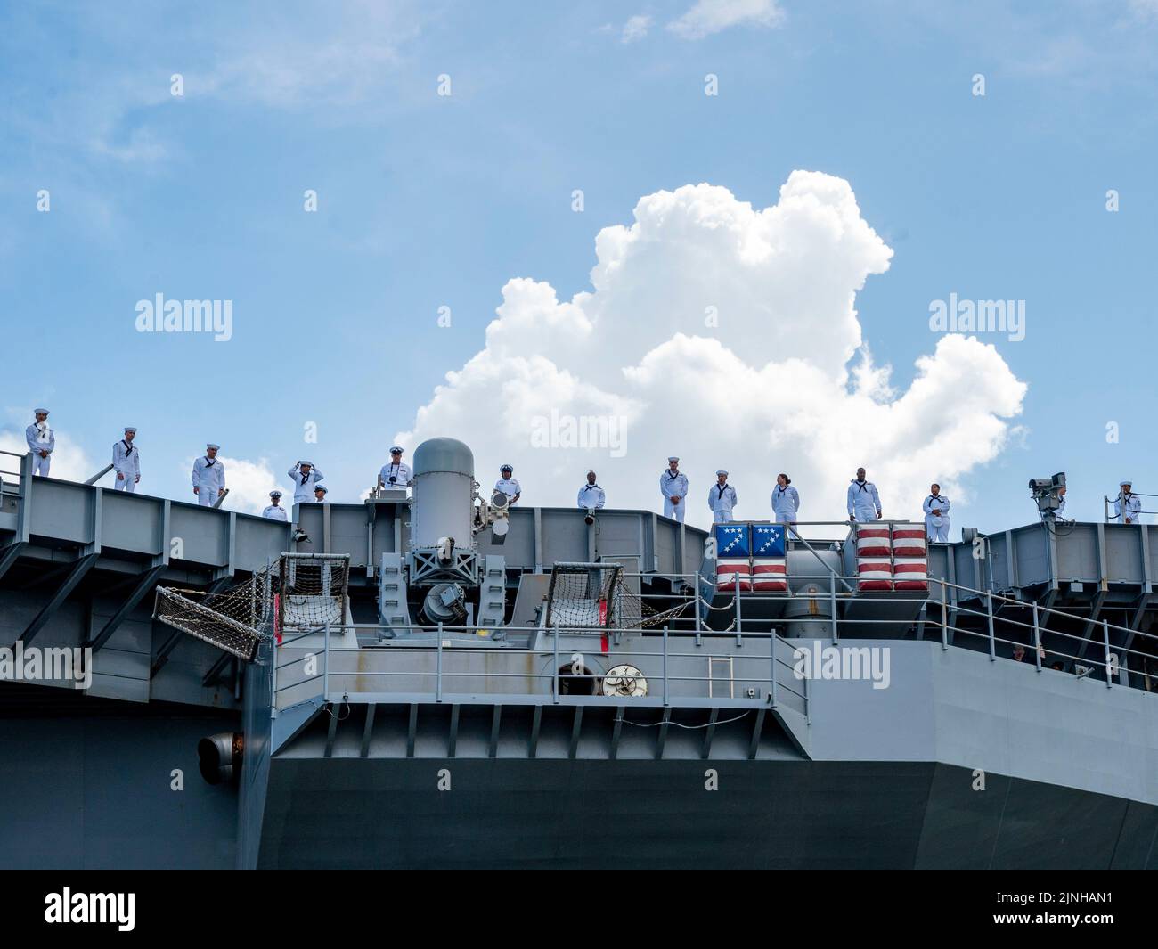 NORFOLK (Aug. 10, 2022) Sailors assigned to the Nimitz-class aircraft carrier USS George H.W. Bush (CVN 77) man the rails as the ship departs Naval Station Norfolk for a scheduled deployment, Aug. 10, 2022. George H.W. Bush provides the national command authority flexible, tailorable warfighting capability as the flagship of a carrier strike group that maintains maritime stability and security to ensure access, deter aggression and defend U.S., allied and partner interests. (U.S. Navy photo by Mass Communication Specialist 1st Class Ryan Seelbach) Stock Photo