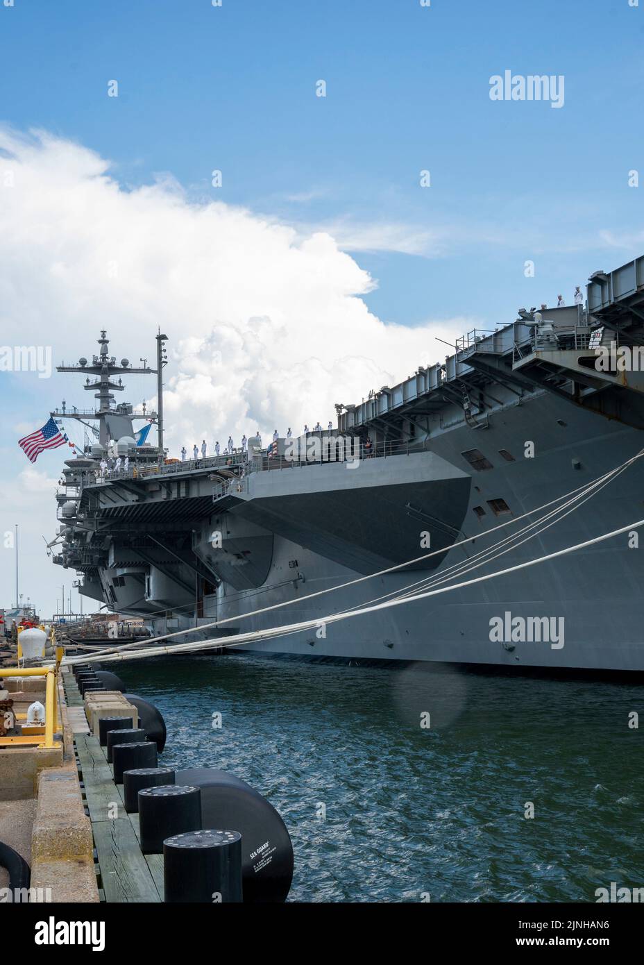 NORFOLK (Aug. 10, 2022) Sailors assigned to the Nimitz-class aircraft carrier USS George H.W. Bush (CVN 77) man the rails as the ship departs Naval Station Norfolk for a scheduled deployment, Aug. 10, 2022. George H.W. Bush provides the national command authority flexible, tailorable warfighting capability as the flagship of a carrier strike group that maintains maritime stability and security to ensure access, deter aggression and defend U.S., allied and partner interests. (U.S. Navy photo by Mass Communication Specialist 1st Class Ryan Seelbach) Stock Photo