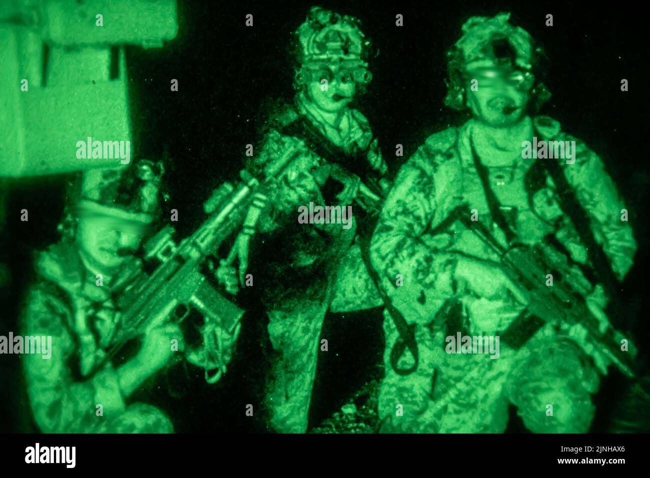 FORT IRWIN, Calif. – Republic of Korea Special Warfare Command (RoK SWC) service members assault an objective under the cover of night with Green Berets from 3rd Battalion, 1st Special Forces Group (Airborne) during an exercise at the National Training Center, Fort Irwin, Calif. on June 29, 2022. This combined training affords opportunities for Soldiers with RoK SWC and 1st SFG (A) to exchange training tactics and techniques. These exercises continue to strengthen Alliances on the peninsula. (U.S. Army photo by Sgt. Thoman Johnson) (This photo has been altered for security purposes.) Stock Photo