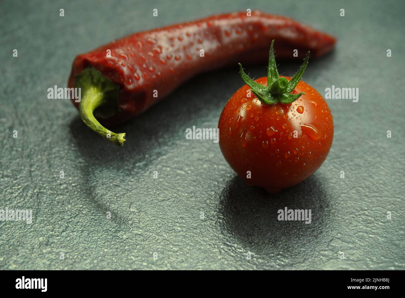 Little tomato and chili pepper. Stock Photo