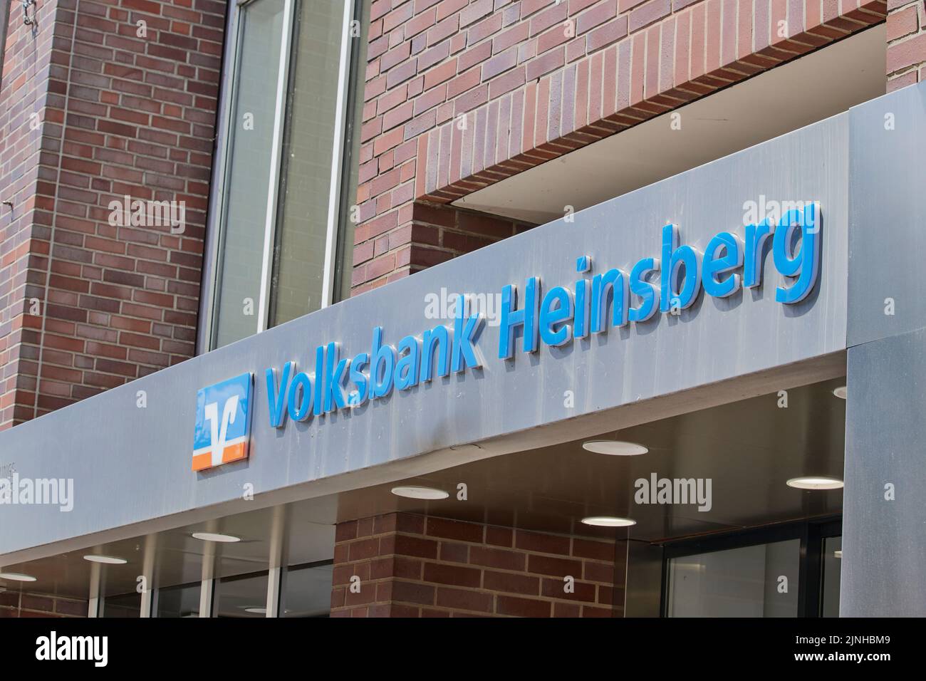 The entrance of the Volksbank with its blue logo in the city of Heinsberg, Germany Stock Photo