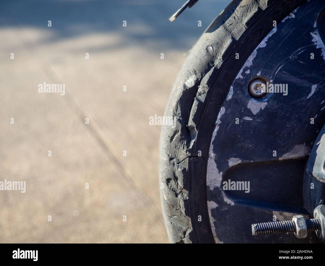 Part of an electric scooter closeup. Broken tire. Broken scooter wheel