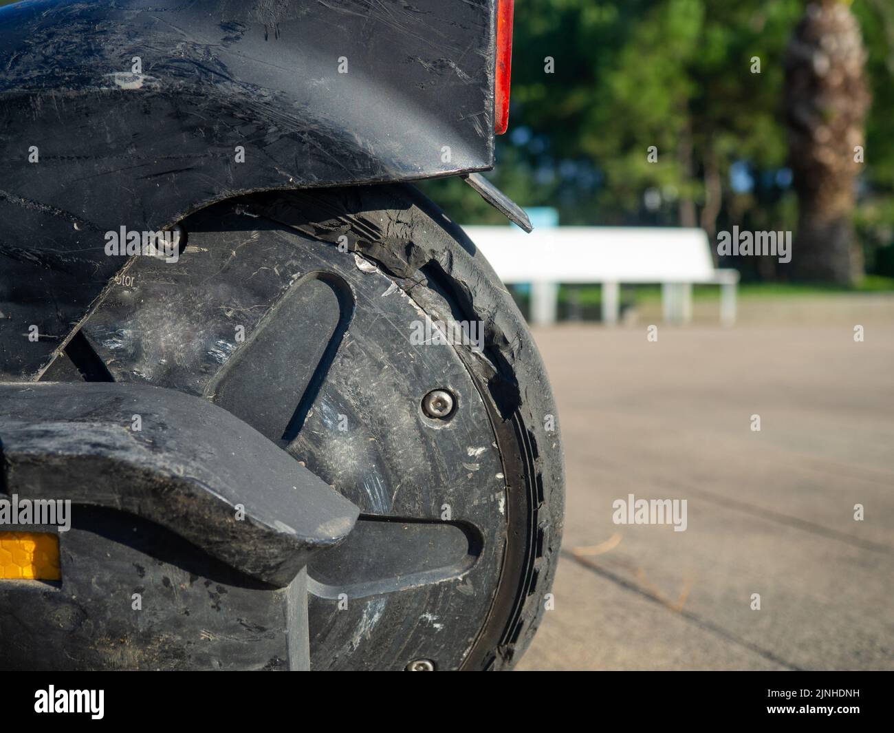 Part of an electric scooter closeup. Broken tire. Broken scooter wheel