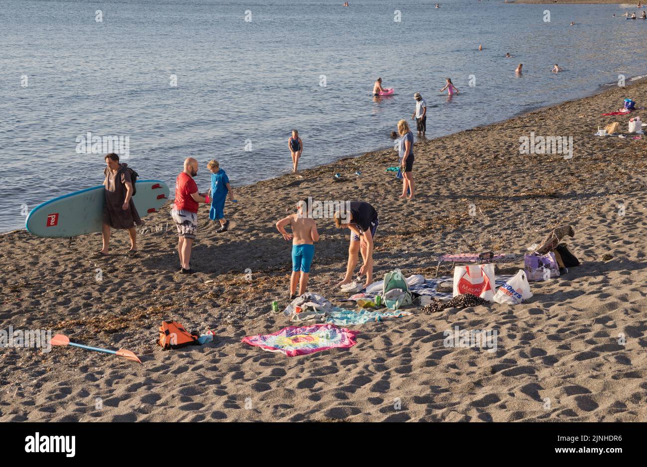 Holidaymakers and families enjoying the sun and swimming in the sea under heatwave on beach in Aberystwyth,Ceredigion,Wales,UK Stock Photo