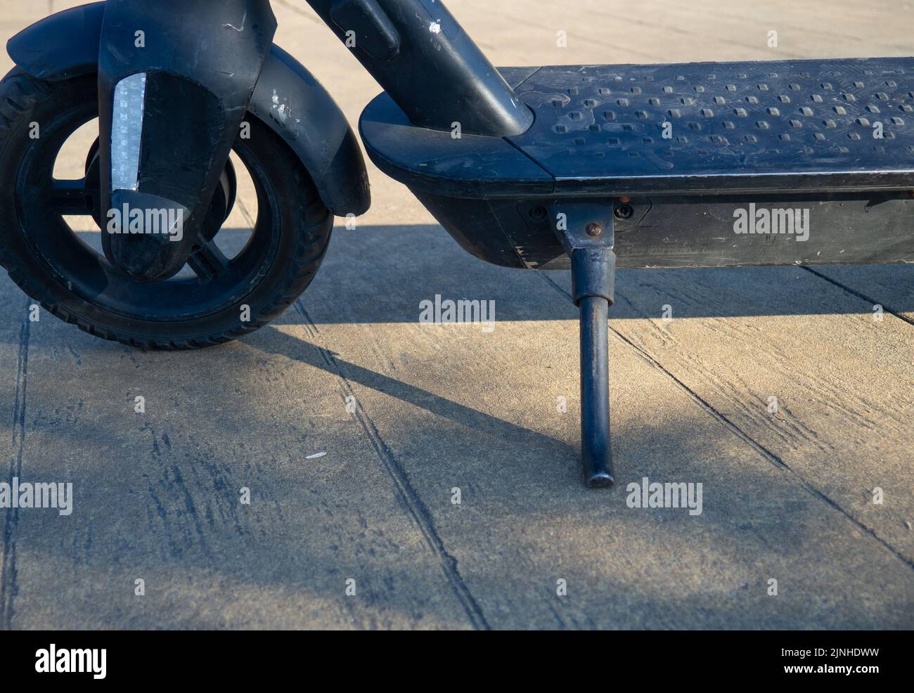 Part of an electric scooter closeup. Scooter on a footboard. Parking