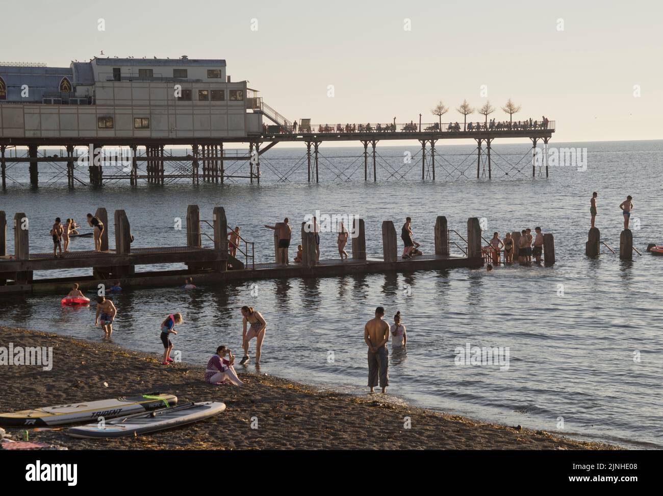 Holidaymakers and families enjoying the sun and swimming in the sea under heatwave on beach in Aberystwyth,Ceredigion,Wales,UK Stock Photo