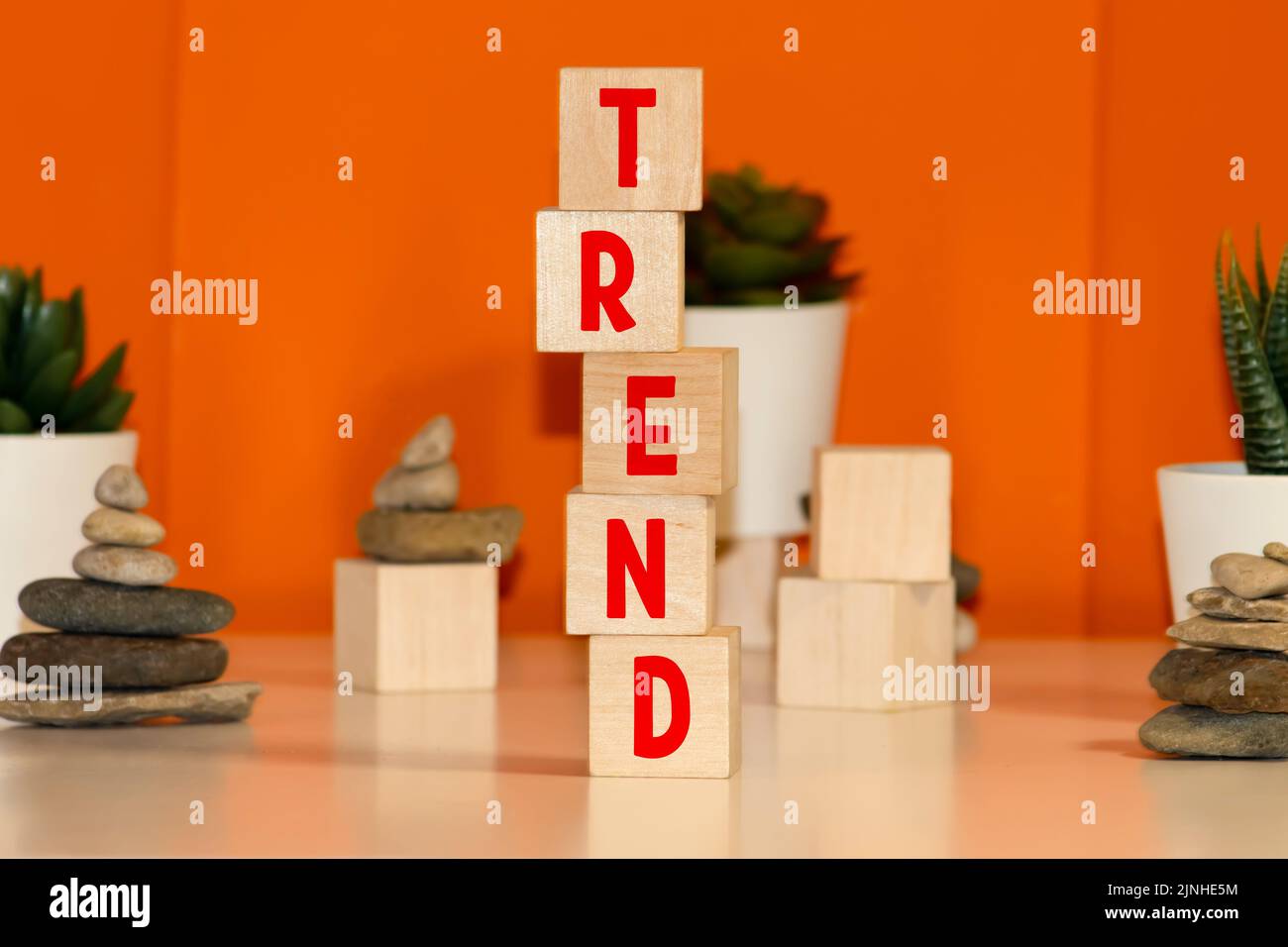 Trend symbol. Concept word Trend on wooden cubes. Beautiful orange background. Business and Trend concept. Copy space. Stock Photo