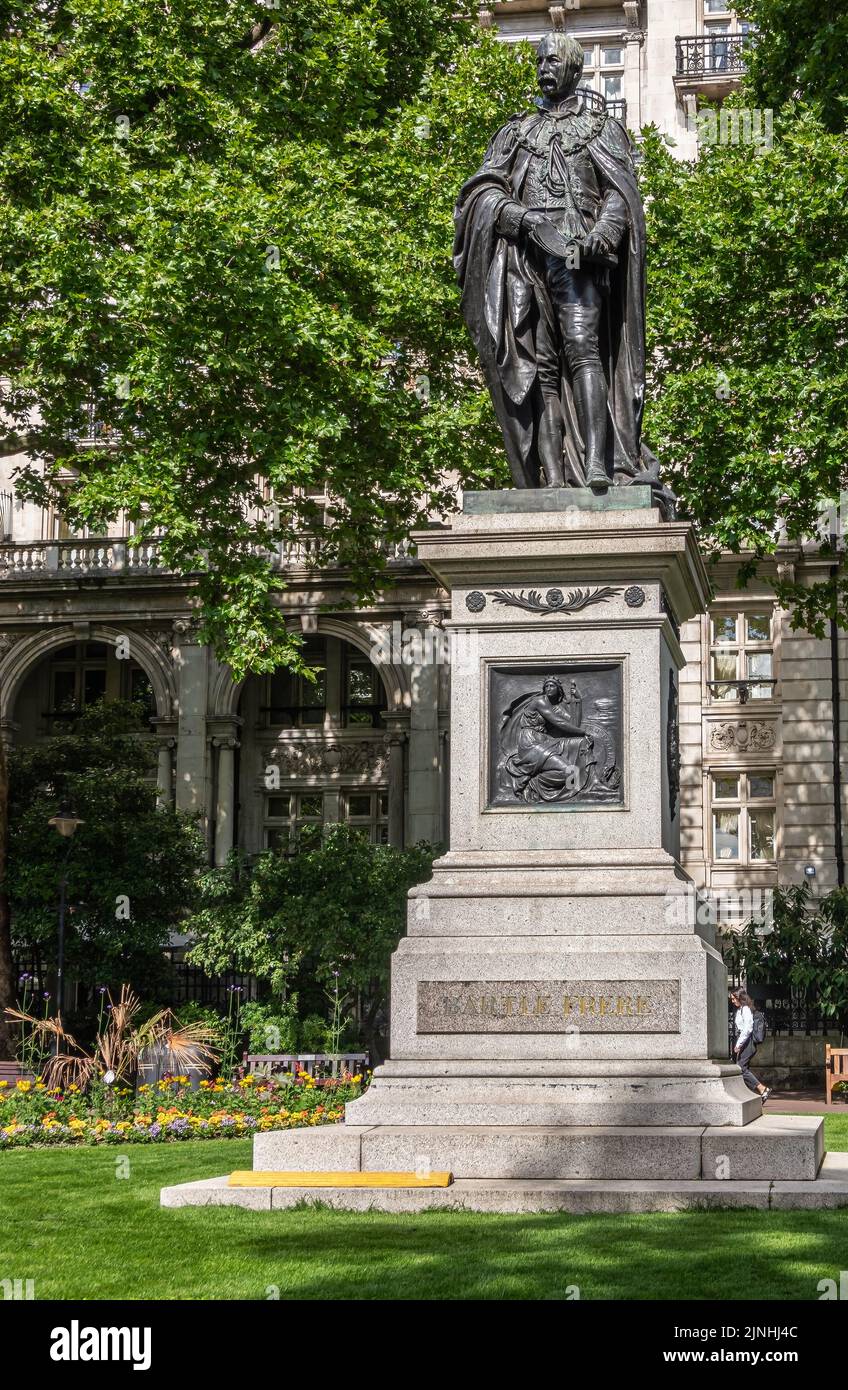 London, UK - July 4, 2022: Whitehall Gardens.  Black bromze Sir Henry Bartle Edward Frere statue on stone pedestal with Pro Patria mural backed by gre Stock Photo
