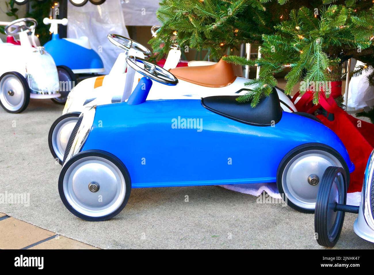 toddler size blue sports car under the tree Stock Photo