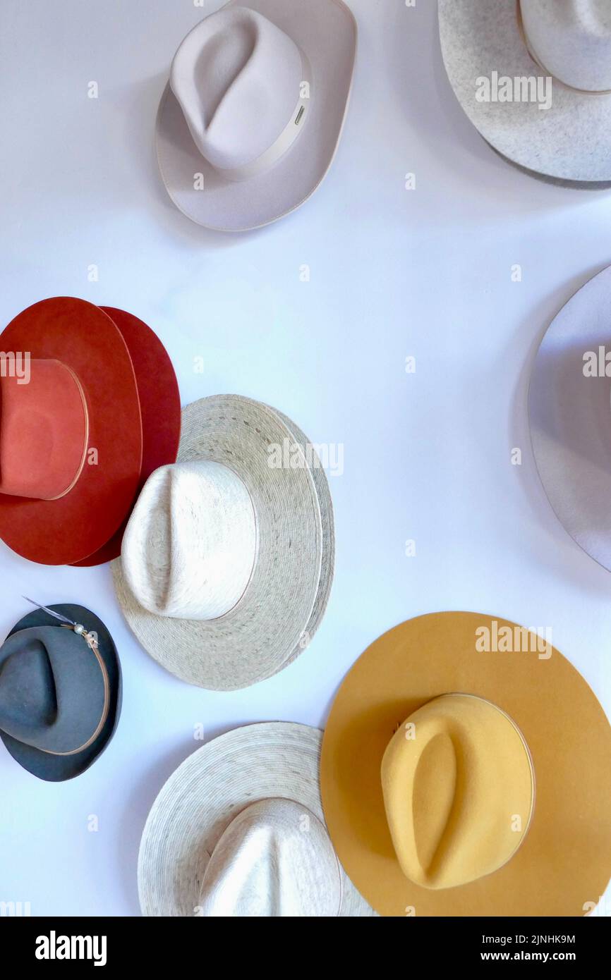 assortment of cowboy hats hanging on the wall Stock Photo Alamy