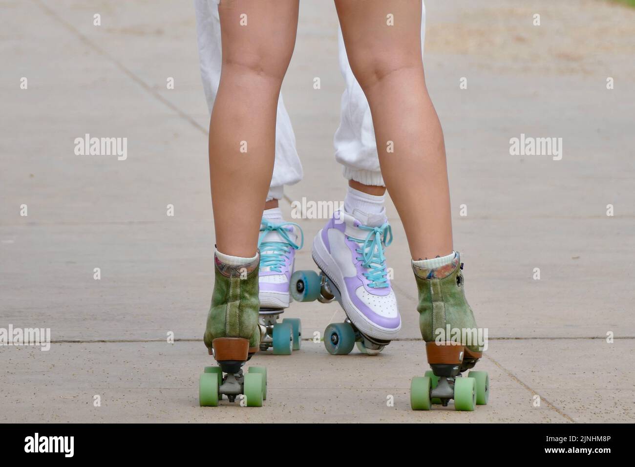 two women dancing on roller skates in the park Stock Photo Alamy
