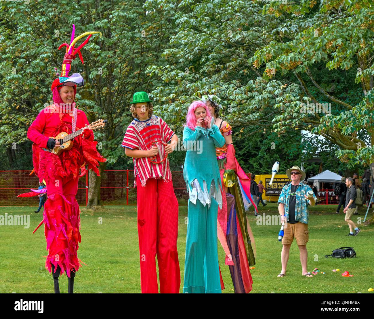 Redbird and stilt walking friends, Vancouver Folk Music Festival, Vancouver, British Columbia, Canada Stock Photo
