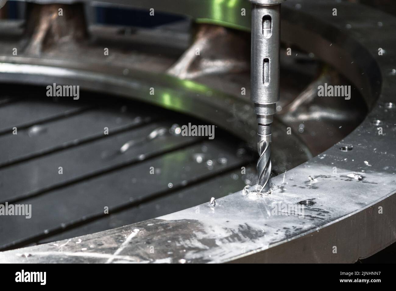 Drilling a hole in a large metal ring. Radial vertical drilling machine