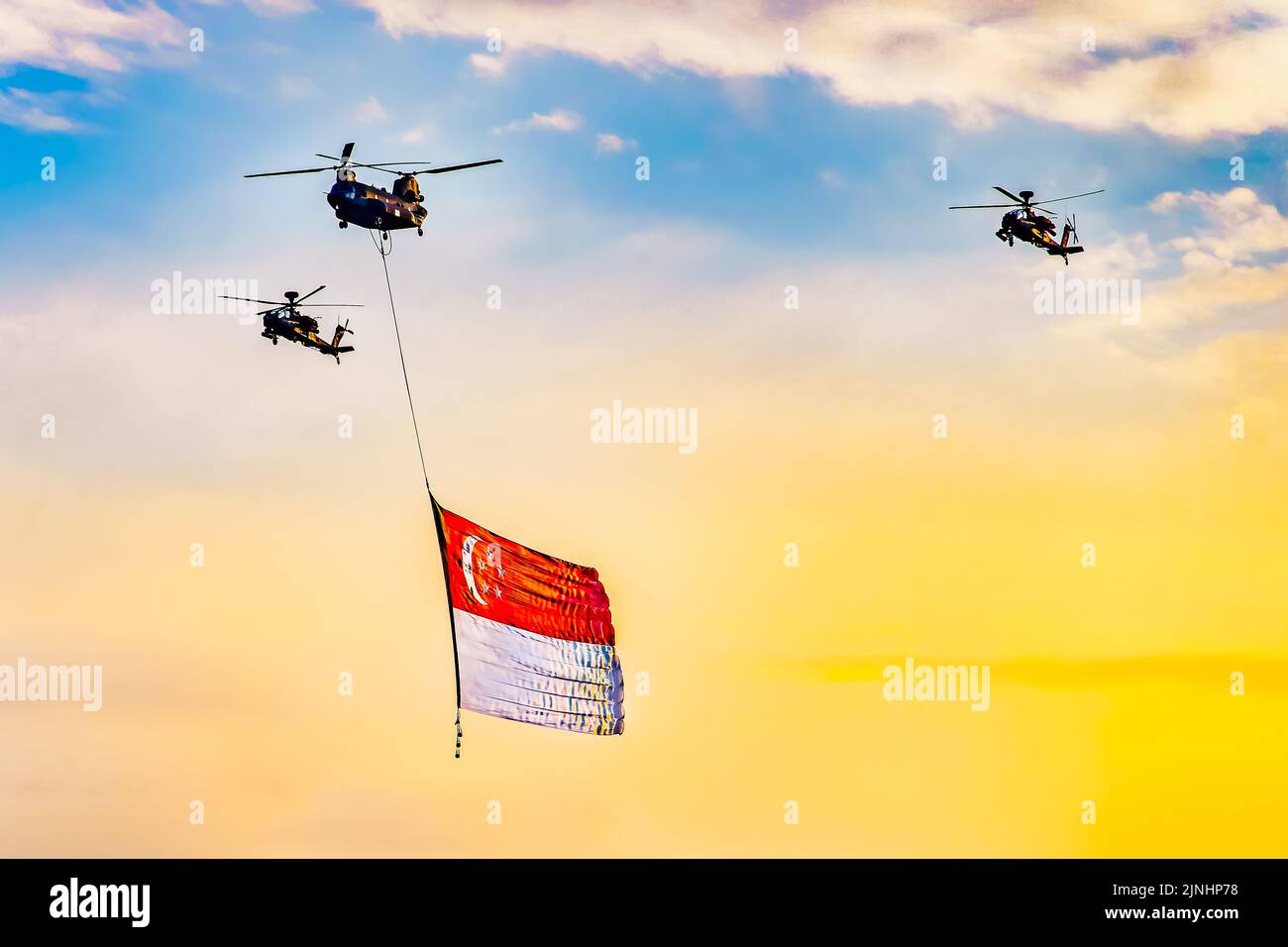 Chinook helicopter flying a giant Singapore national flag during National Day Parade. Stock Photo
