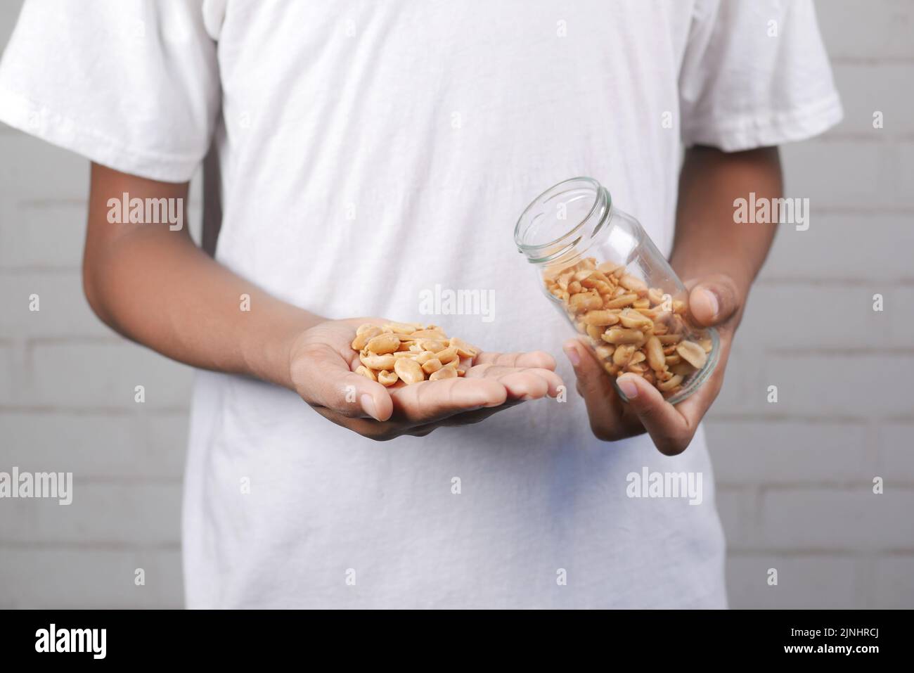 young men eating Processed pea nuts Stock Photo