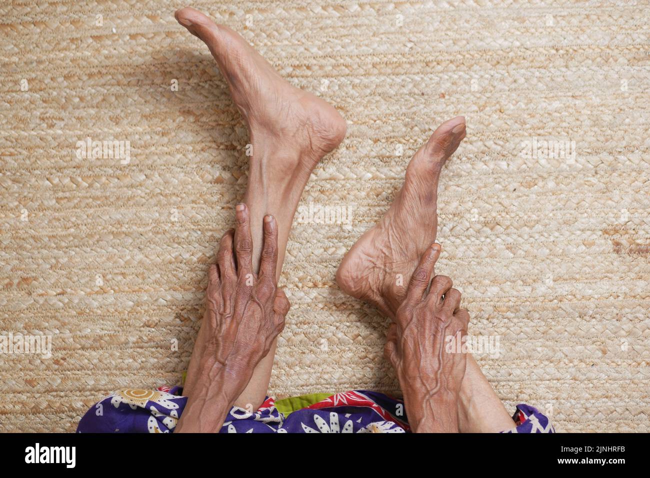 senior women feet and hand massage on injury spot. Stock Photo