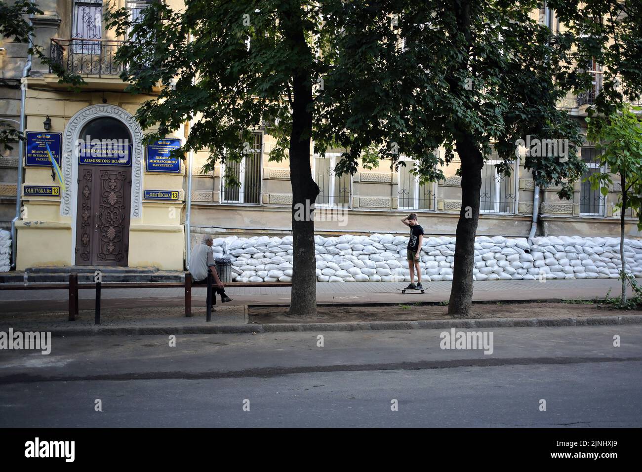 Odessa, Ukraine. 11th Aug, 2022. A man on a skateboard moves past sandbags. Credit: SOPA Images Limited/Alamy Live News Stock Photo