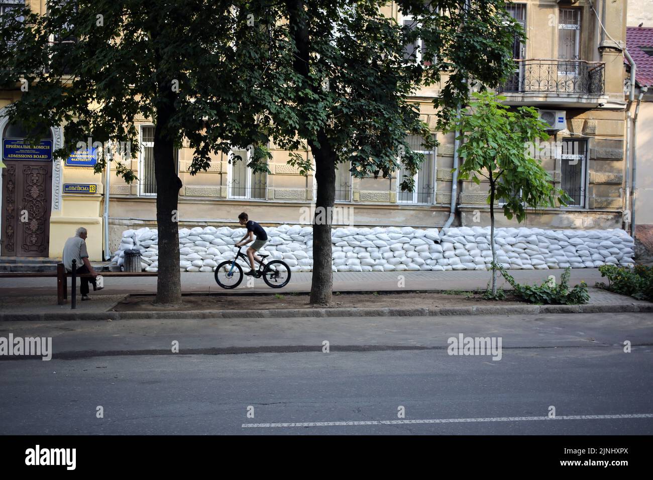 Odessa, Ukraine. 11th Aug, 2022. A man on a bike rides past sandbags. (Photo by Viacheslav Onyshchenko/SOPA Images/Sipa USA) Credit: Sipa USA/Alamy Live News Stock Photo