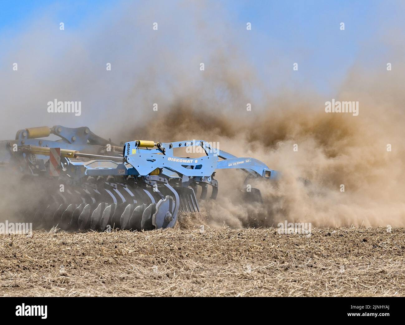 Sieversdorf, Germany. 10th Aug, 2022. A farmer drives a tractor and a ...