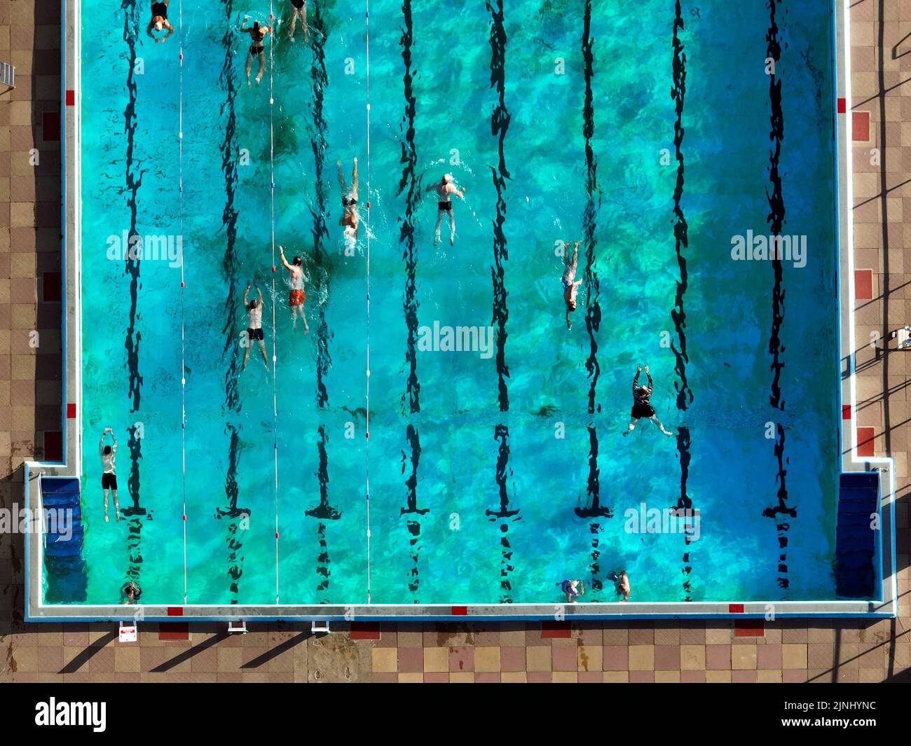 Swimmers enjoy a cooling dip in the Peterborough Lido as the prolonged