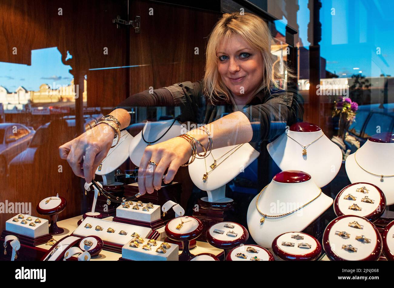 A shop assistant arranging the window of a jewellers in Kalgoorlie, Western Australia Stock Photo